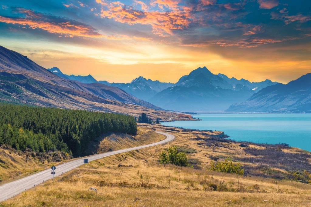 Road New Zealand with panoramic mountains and lake